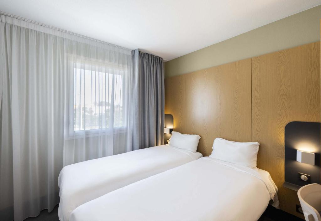 Postel nebo postele na pokoji v ubytování B&B HOTEL Perpignan Sud Marché International