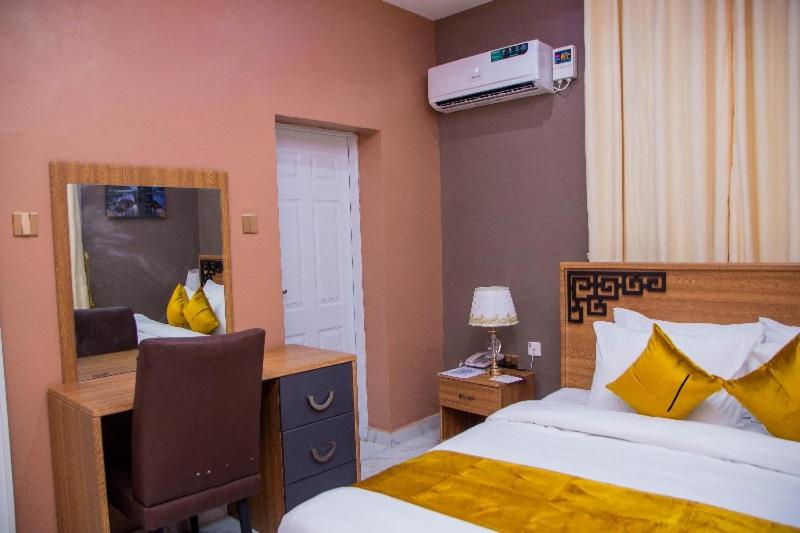 Postel nebo postele na pokoji v ubytování De-Lites Hotel