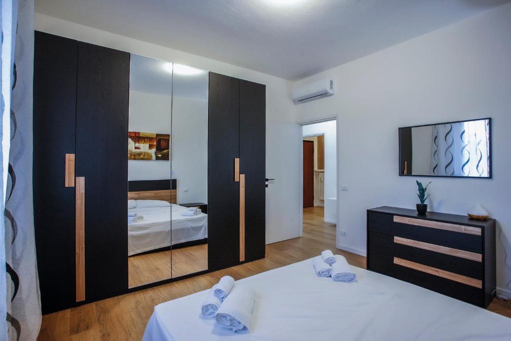 a bedroom with a bed and a large mirror at Bella Ciao BGY Airport in Zanica