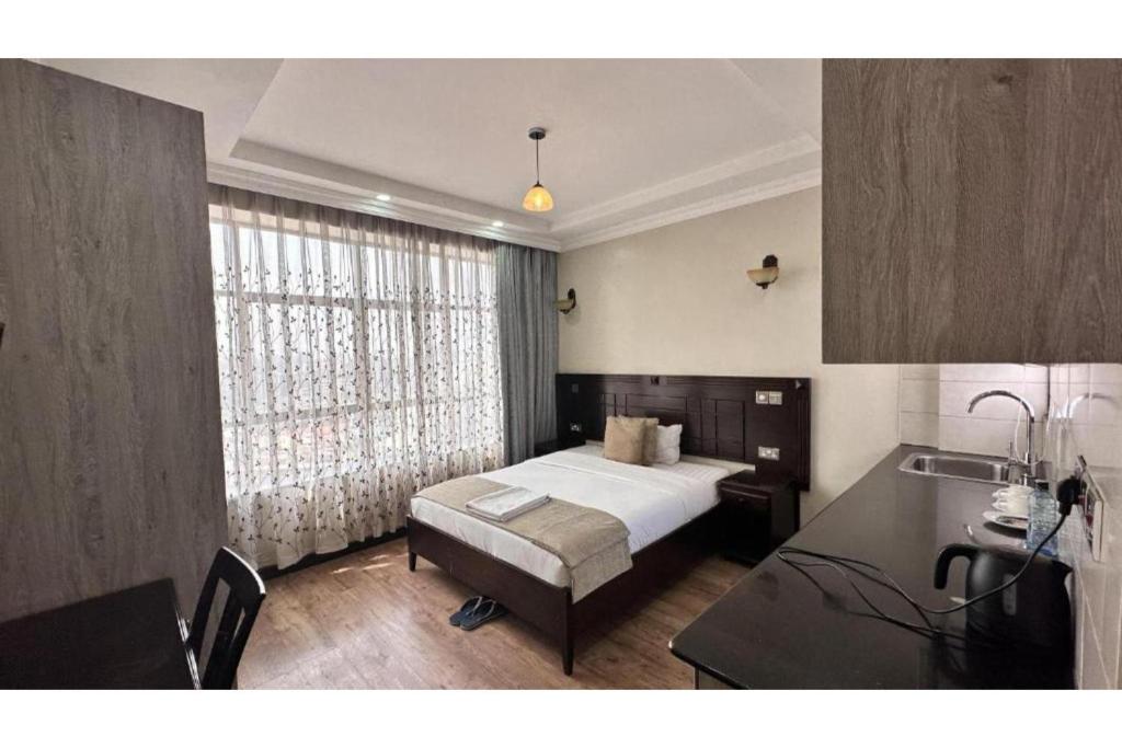 Postel nebo postele na pokoji v ubytování Hemak Suites Hotel