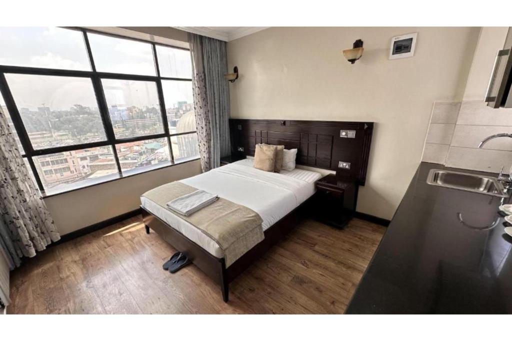 Postel nebo postele na pokoji v ubytování Hemak Suites Hotel