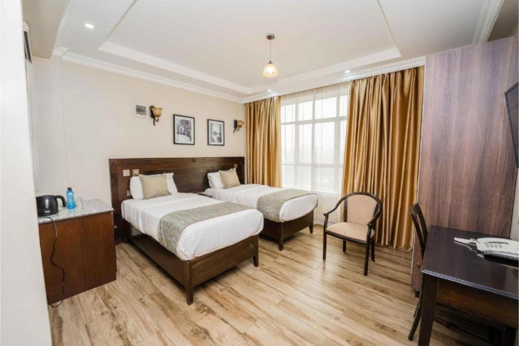 Postel nebo postele na pokoji v ubytování Hemak Suites Hotel