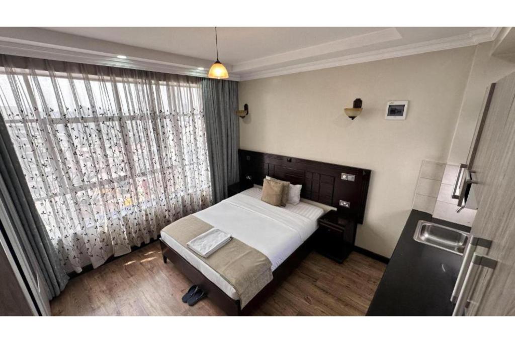 Postel nebo postele na pokoji v ubytování Hemak Suites Hotel