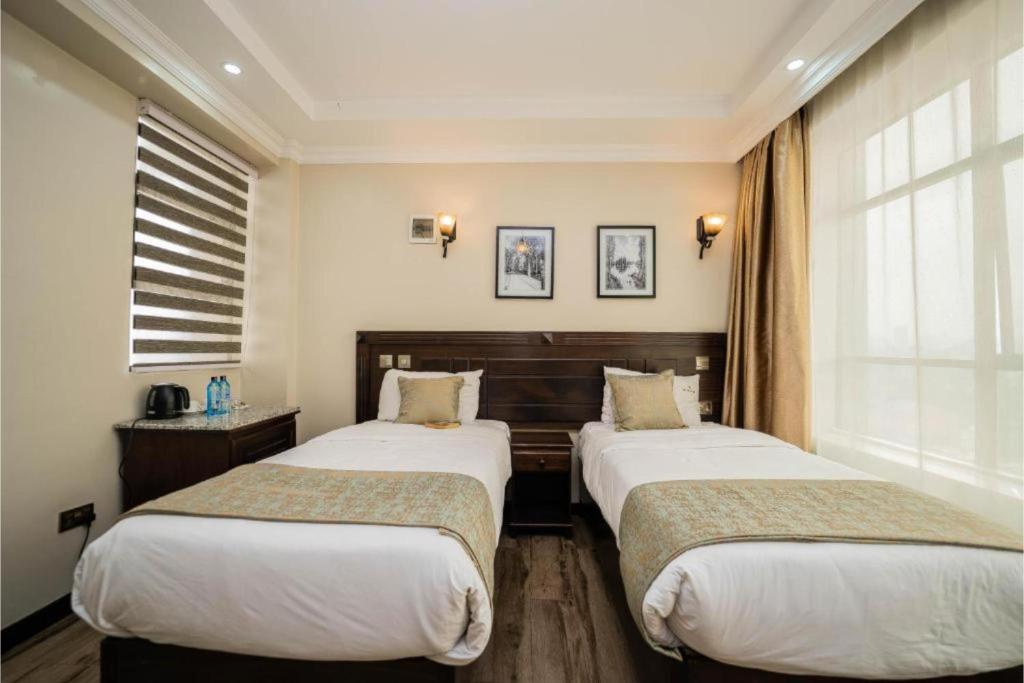 Postel nebo postele na pokoji v ubytování Hemak Suites Hotel