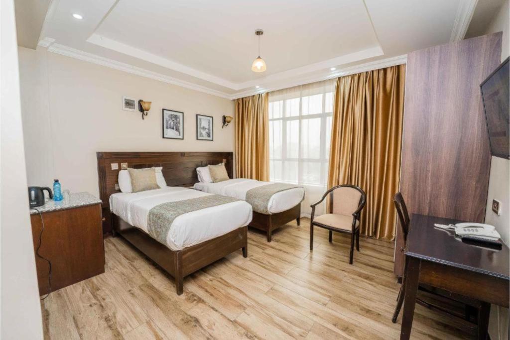 Postel nebo postele na pokoji v ubytování Hemak Suites Hotel