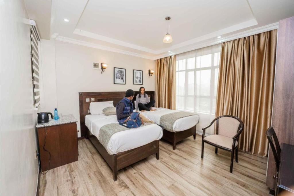Postel nebo postele na pokoji v ubytování Hemak Suites Hotel