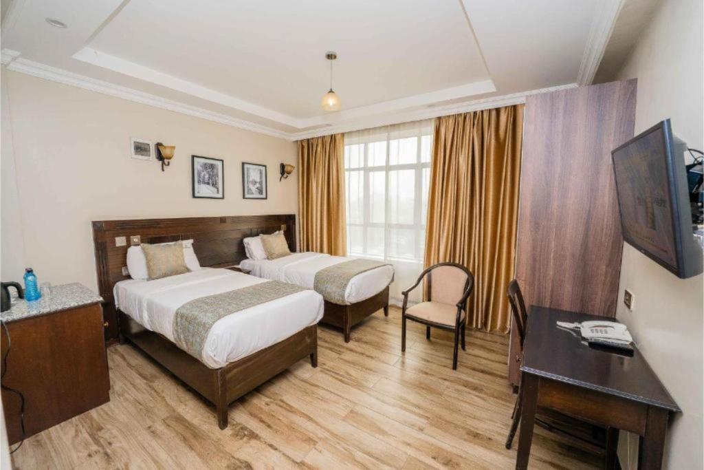 Postel nebo postele na pokoji v ubytování Hemak Suites Hotel