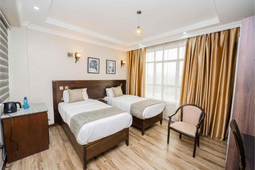 Postel nebo postele na pokoji v ubytování Hemak Suites Hotel