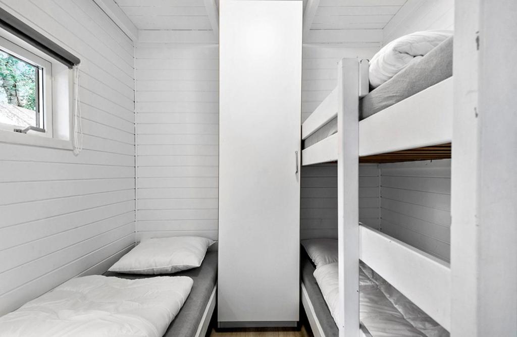 Postel nebo postele na pokoji v ubytování First Camp Ajstrup Strand