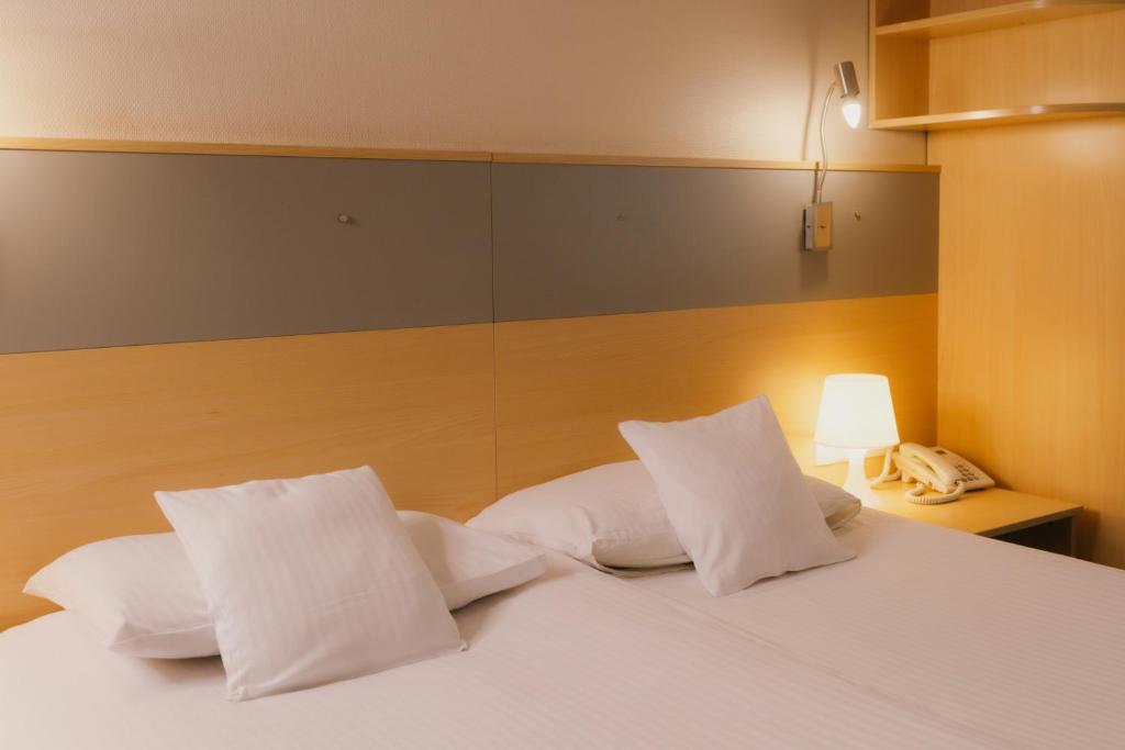 Postel nebo postele na pokoji v ubytování Quality Silesian Hotel