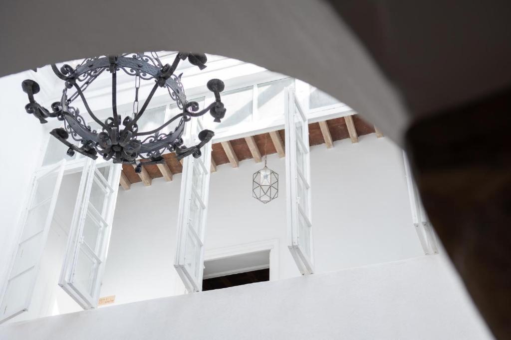 a chandelier hanging from the ceiling of a building at El Palacio del Viento Apartamentos in Tarifa