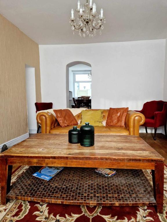 a living room with a couch and a coffee table at Large Victorian Townhouse in Buxton