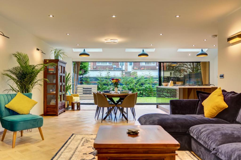 a living room with a couch and a table at Lovely South Downs Town House in Upper Beeding
