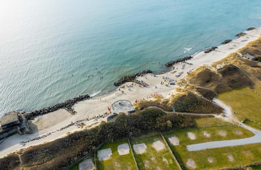 an aerial view of a beach and the ocean at First Camp Grenen Strand in Skagen