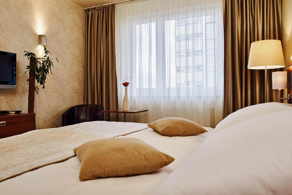 Postel nebo postele na pokoji v ubytování Privilege Apartments