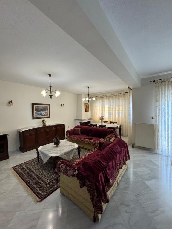a large living room with a couch and a table at Triangle Park Apartments A1 in Kozani