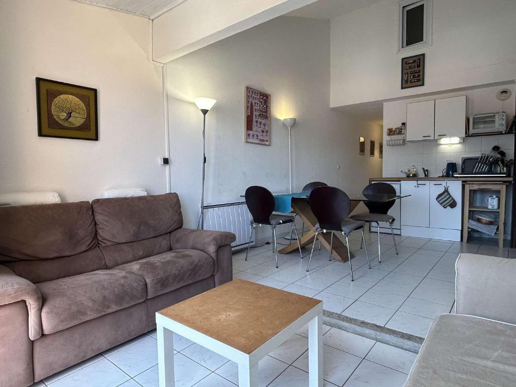 un salon avec un canapé et une table et une cuisine dans l'établissement Appart 3 pièces 5 couchages BANYULS SUR MER BN090-F18, à Banyuls-sur-Mer