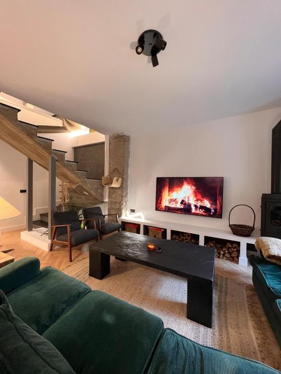 a living room with a couch and a fireplace at Casa boutique-rural en El Bierzo in Torre del Bierzo