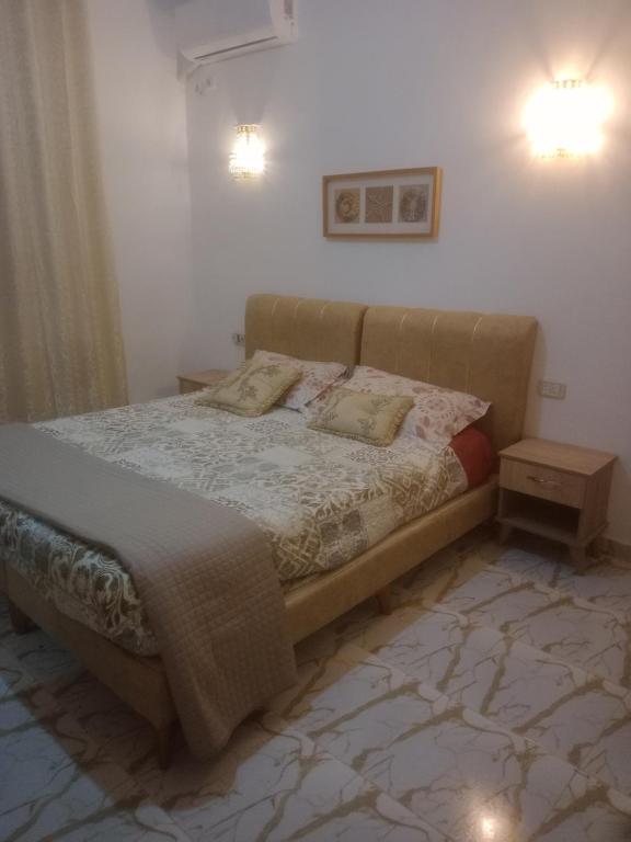 a bed in a bedroom with two pillows on it at Sousse appartement sahloul in Sousse