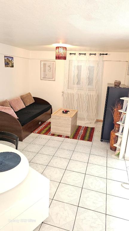 un salon avec un lit et une table dans l'établissement 3 rue Maurice Utrillo, à Bourg-en-Bresse