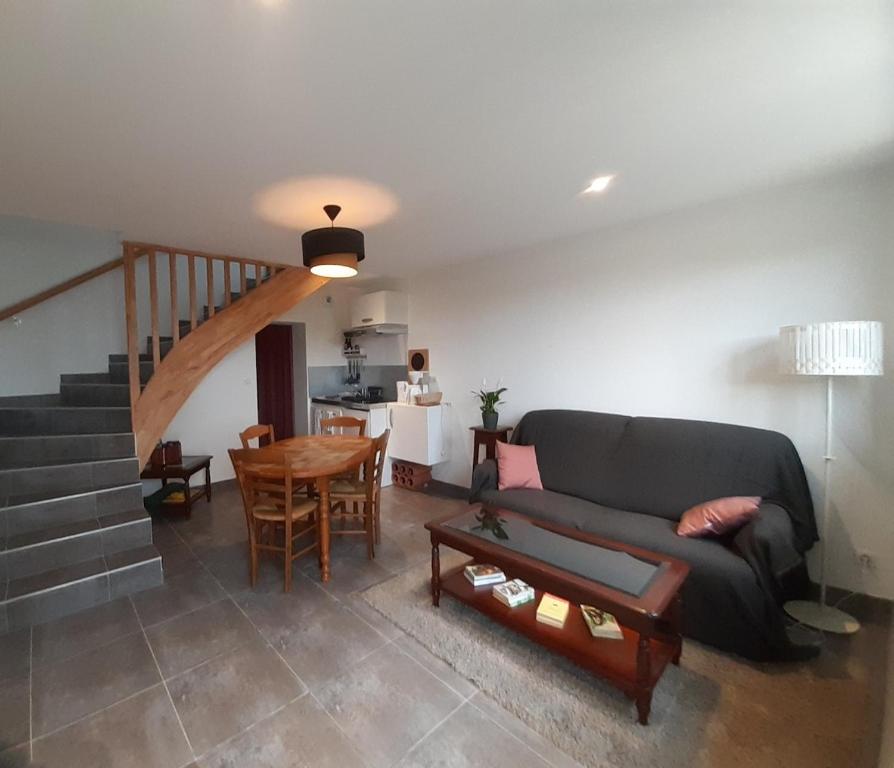 a living room with a couch and a table at Gîte Volcans in Gelles