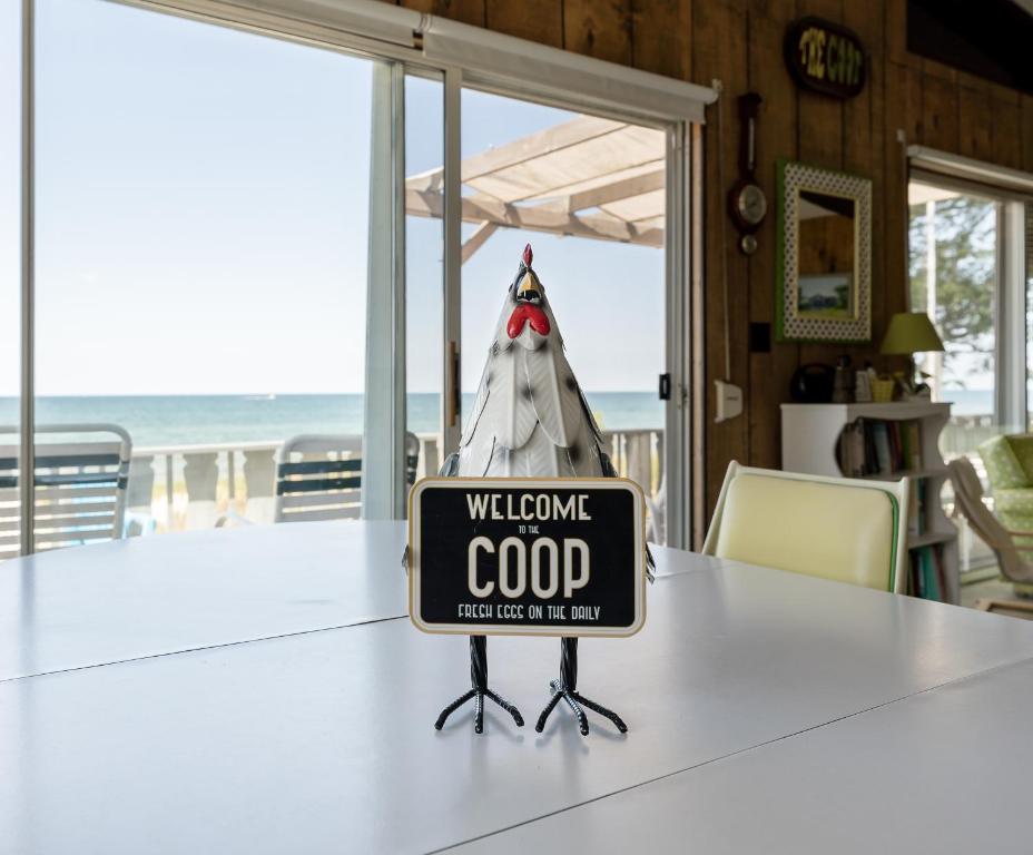 a sign that reads welcome god sitting on a table at Beachfront cottage on North Shore Grand Haven in Spring Lake