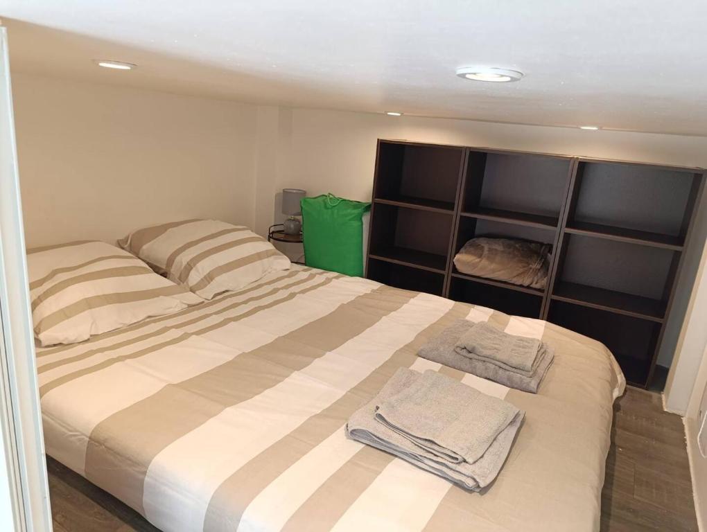 une chambre avec un lit avec deux serviettes dessus dans l'établissement Studio climatisé, à Nice