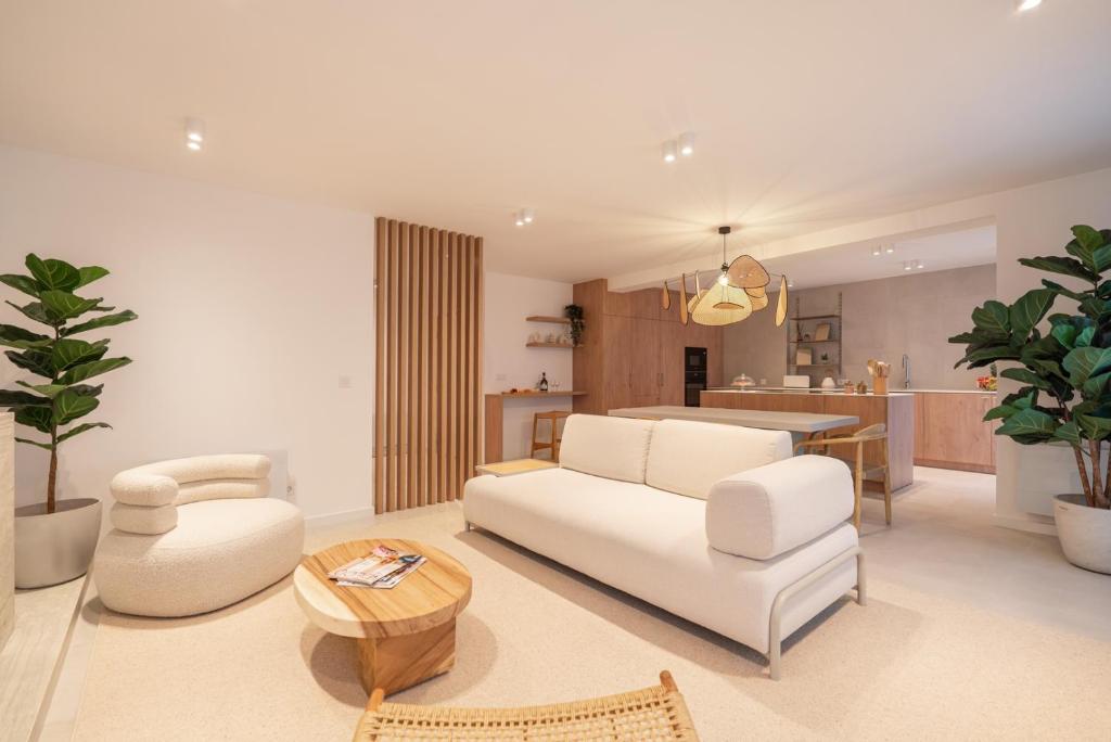 a living room with a white couch and a table at Stylish & Spacious Flat near the Beach by HostWise in Matosinhos