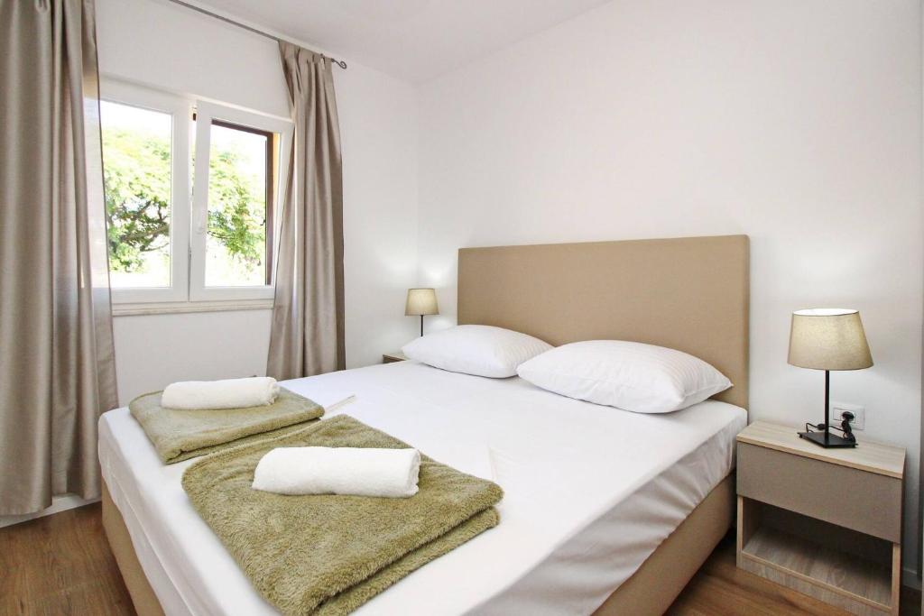 Postel nebo postele na pokoji v ubytování Sunshine Residence Baska