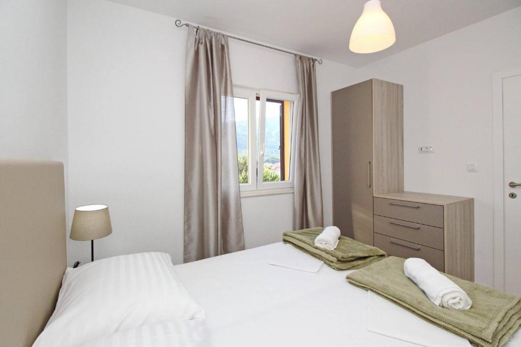 Postel nebo postele na pokoji v ubytování Sunshine Residence Baska
