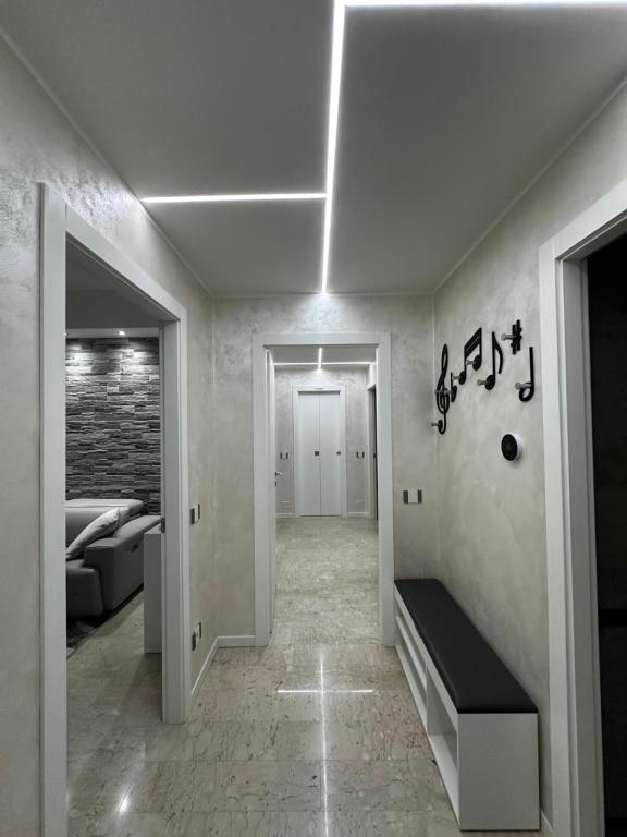 a room with a hallway with a couch and a staircase at Amazing Varese Central Apartment in Varese