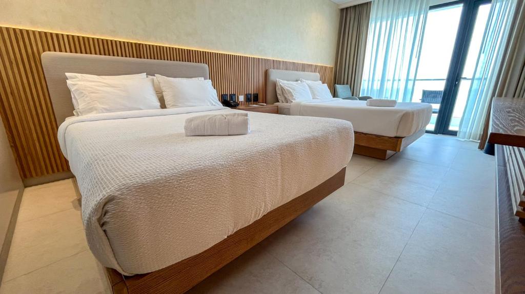 Postel nebo postele na pokoji v ubytování MantaHost Hotel