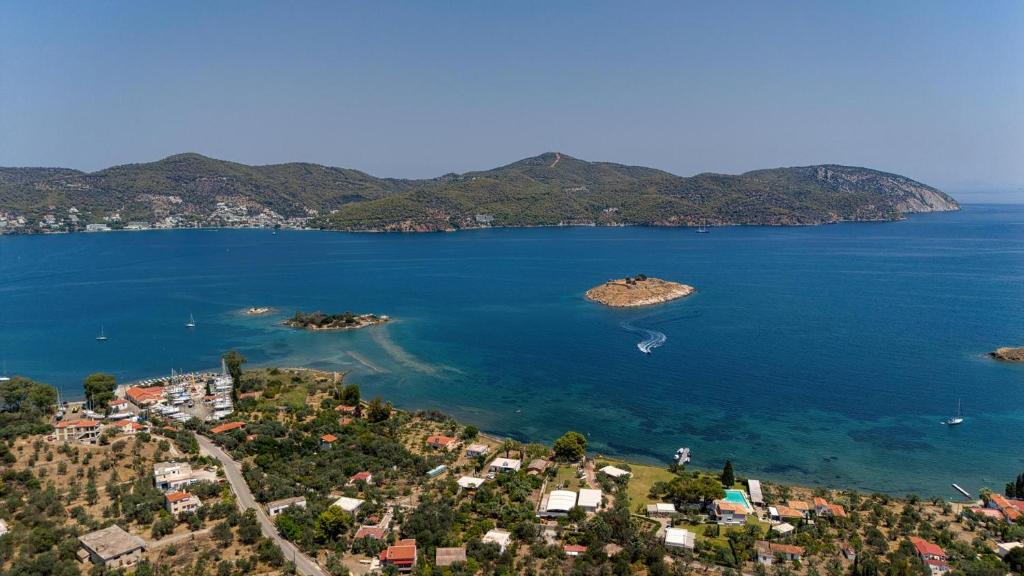 an island in the middle of a large body of water at Poetree Echo by Green Poetree Houses in Galatas