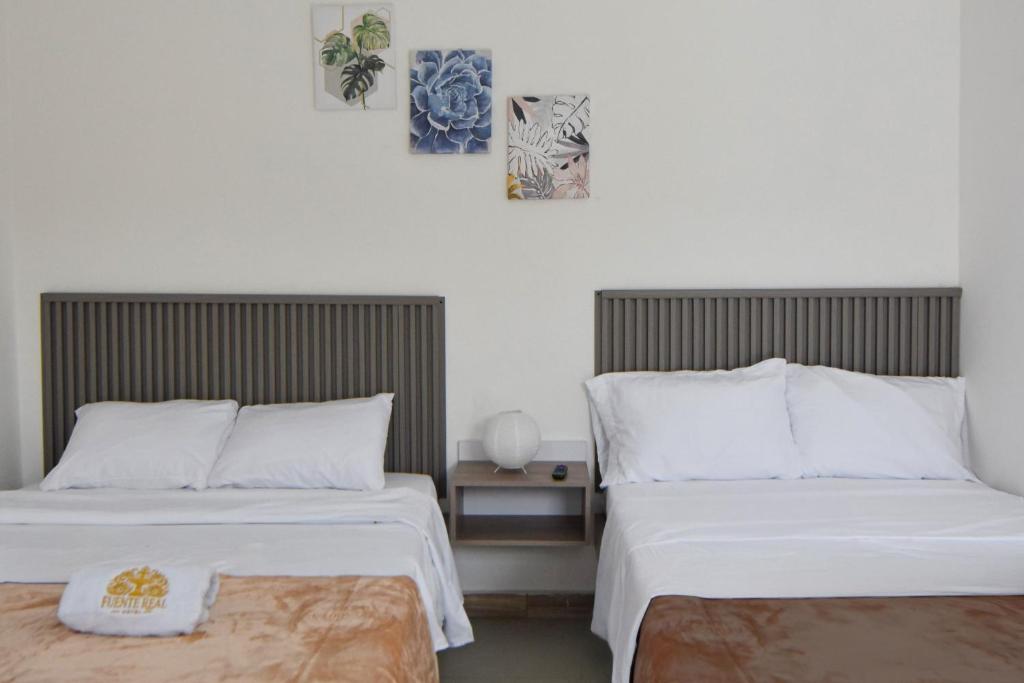 Postel nebo postele na pokoji v ubytování Hotel Fuente Real Popayán