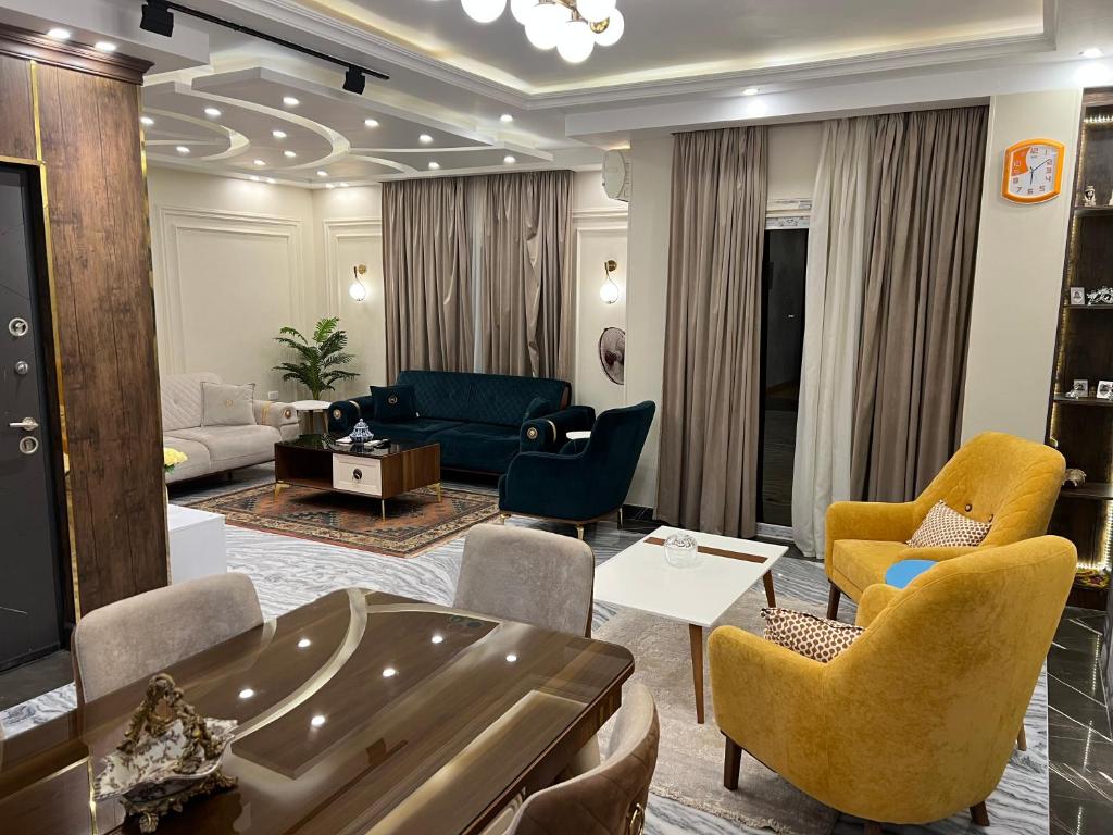 a living room with a couch and chairs at The Royal Apartment at New Cairo الشقة الملكية بالقاهره الجديدة in Cairo