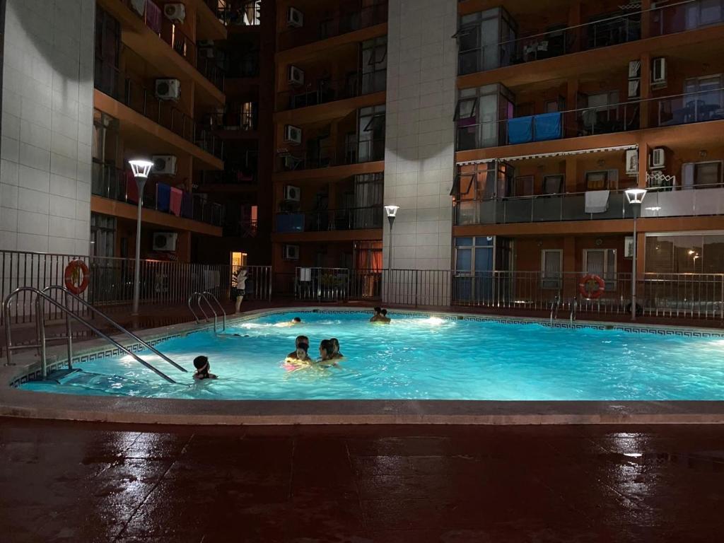 a group of people in a swimming pool in a building at Algaida oropesa in Oropesa del Mar