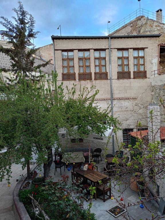 an outdoor patio with tables and chairs and a building at Keyf i ala capadocia in Ürgüp