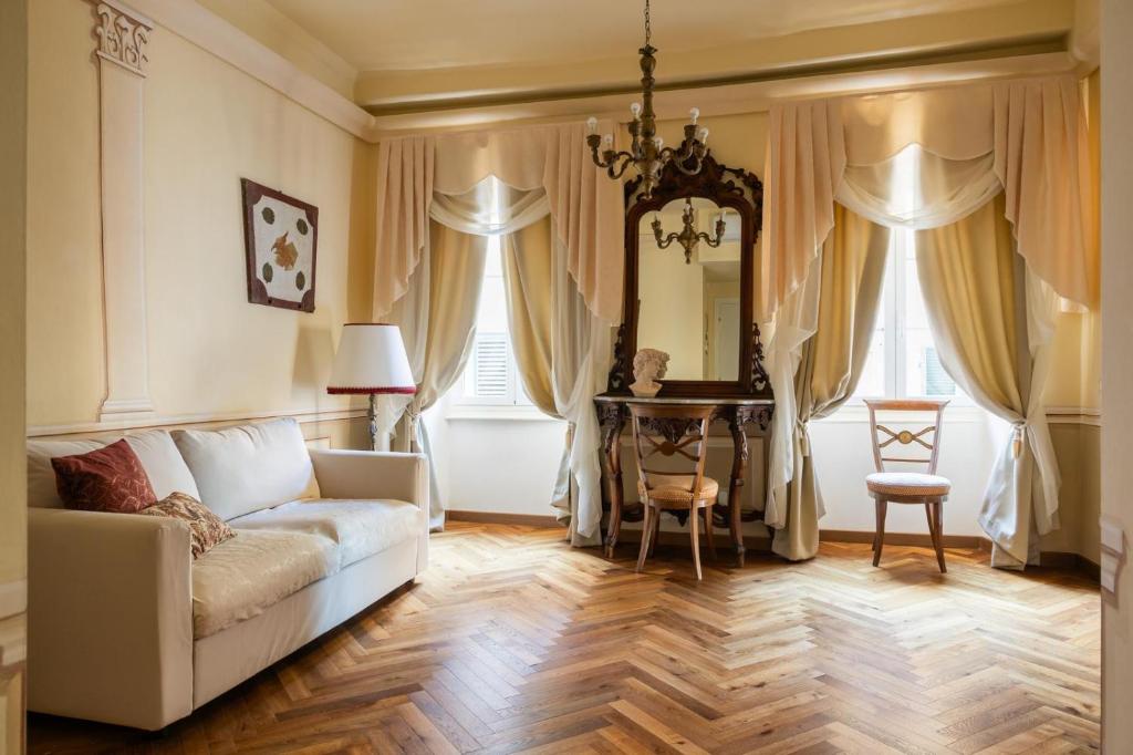 a living room with a couch and a table at Palazzo Lari Sarzana in Sarzana