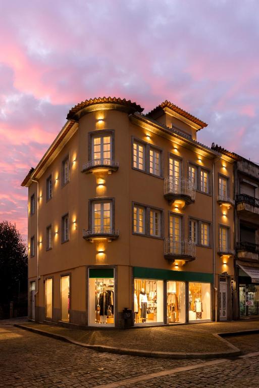 a large building with lights on the side of it at Carvoeiro Boutique Apartments in Amarante