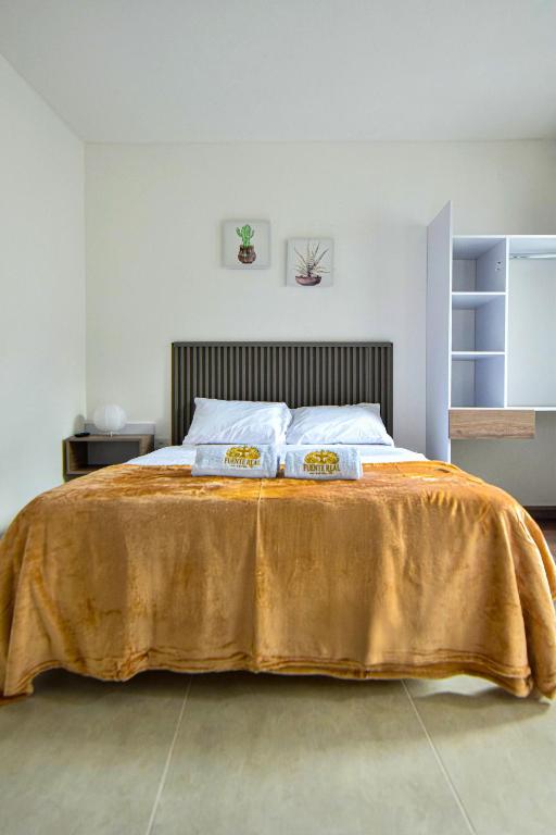 Postel nebo postele na pokoji v ubytování Hotel Fuente Real Popayán
