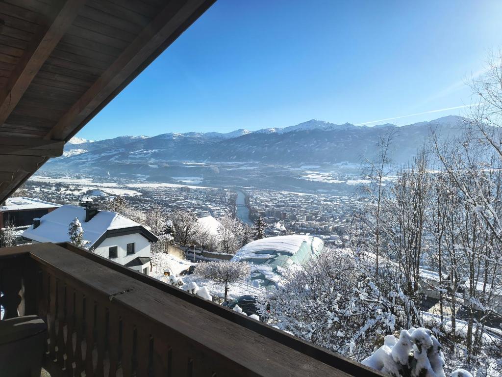 a view from the balcony of a house in the snow at Alpendohle Apartments Innsbruck in Innsbruck