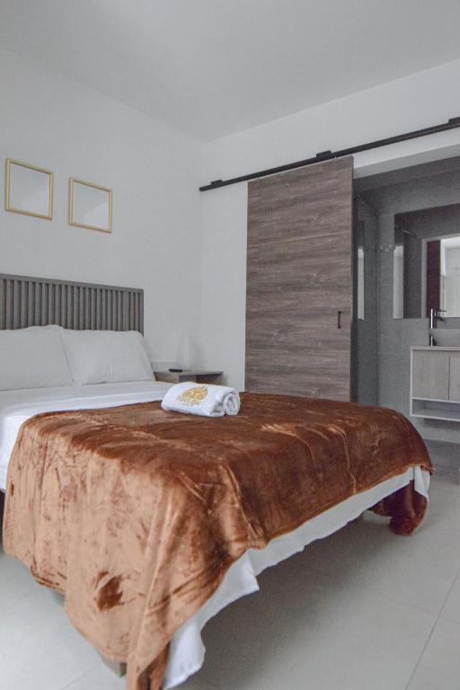Postel nebo postele na pokoji v ubytování Hotel Fuente Real Popayán