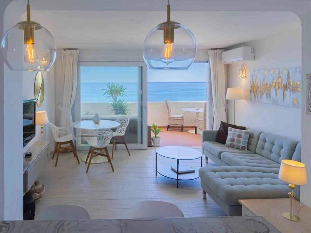 a living room with a couch and a table at Bliss Luz Horizon - Panoramic Sea View - 50m to Beach - Central Praia da Luz - Walk distance to Everywhere in Luz
