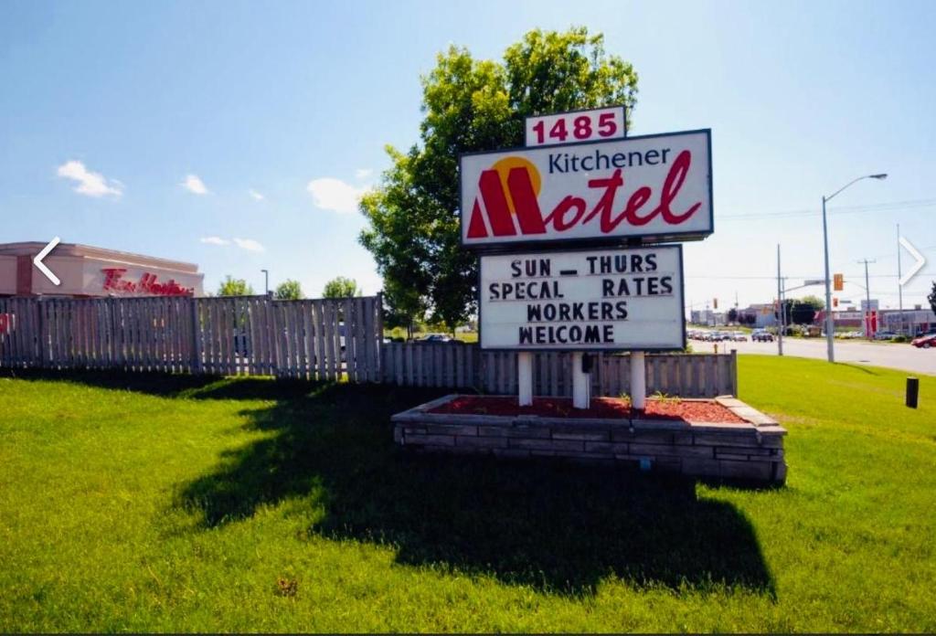 a sign for a motel in a field at Kitchener Motel in Kitchener