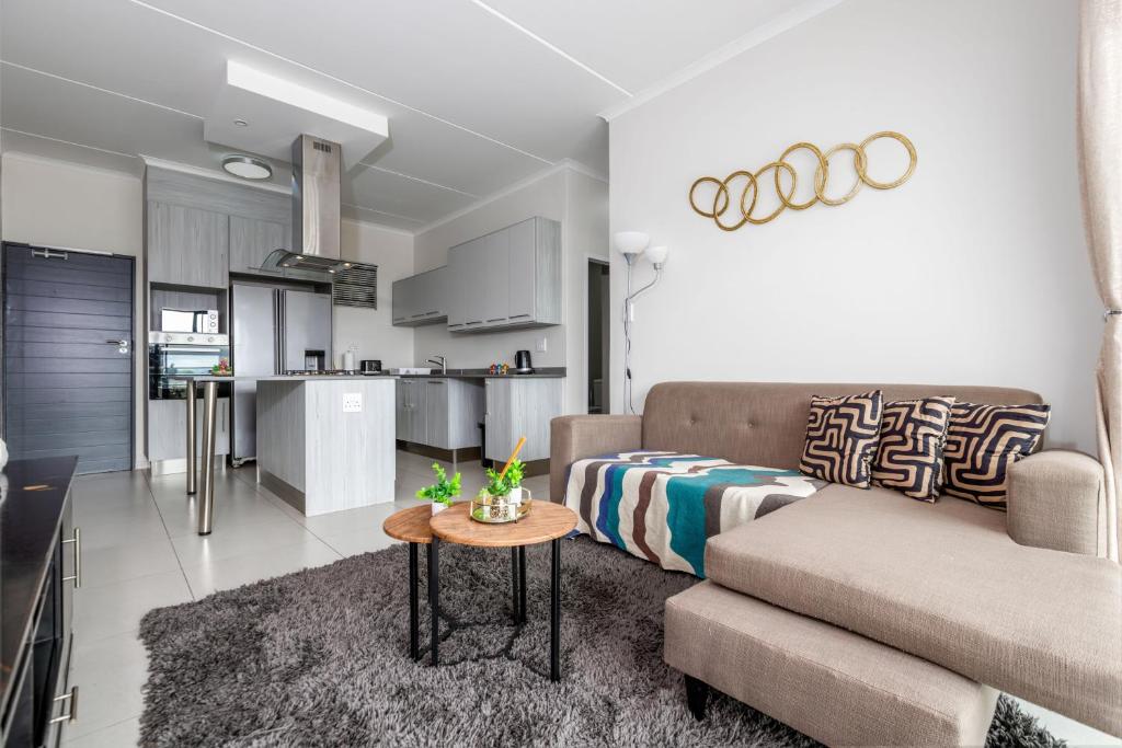 a living room with a couch and a table at Fredas Place 92 On New in Midrand