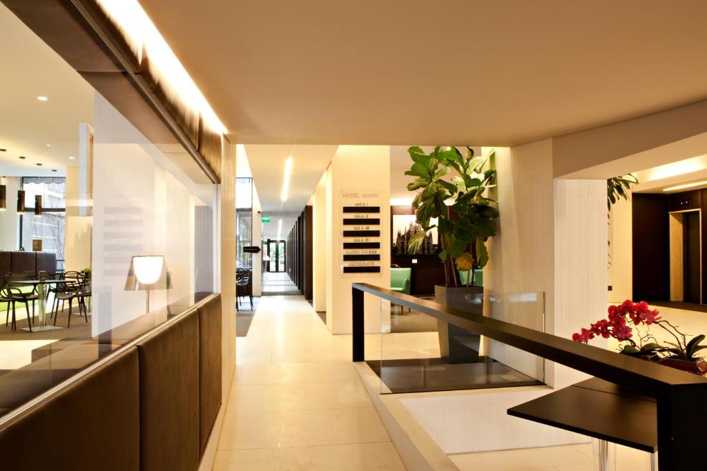 a hallway of a house with stairs and plants at Hotel Manin in Milan