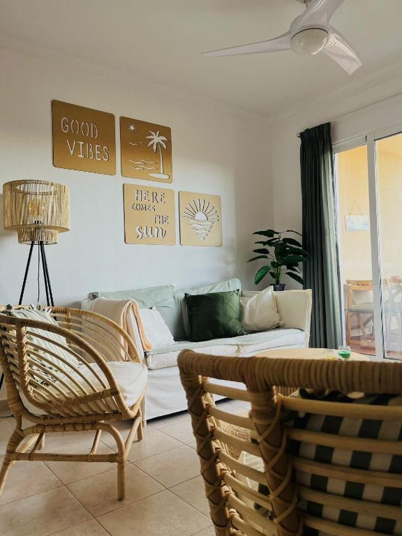 a living room with a white couch and chairs at Casa Soñada -Appartment with pool and garage in Los Alcázares