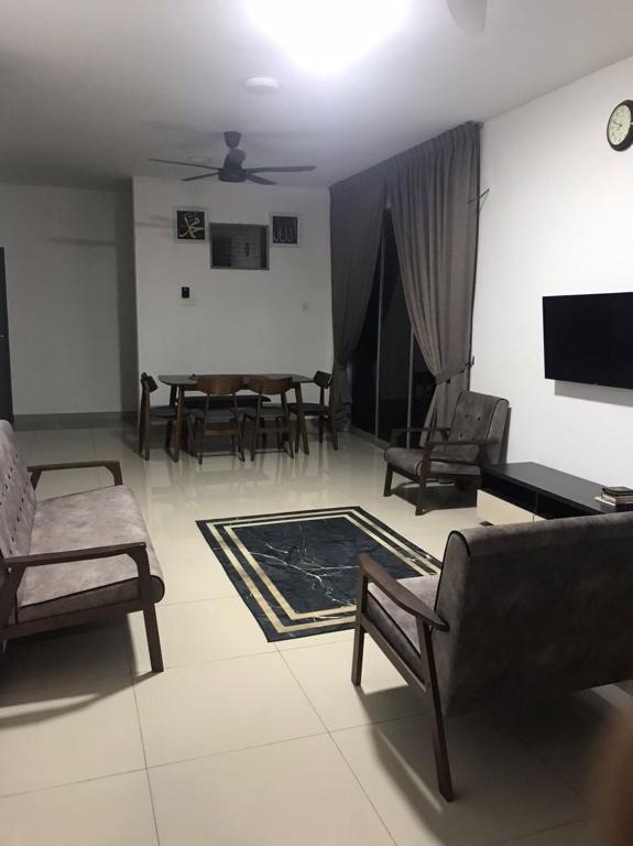 a living room with a couch and chairs and a table at Homestay hanamuslim senawang in Seremban