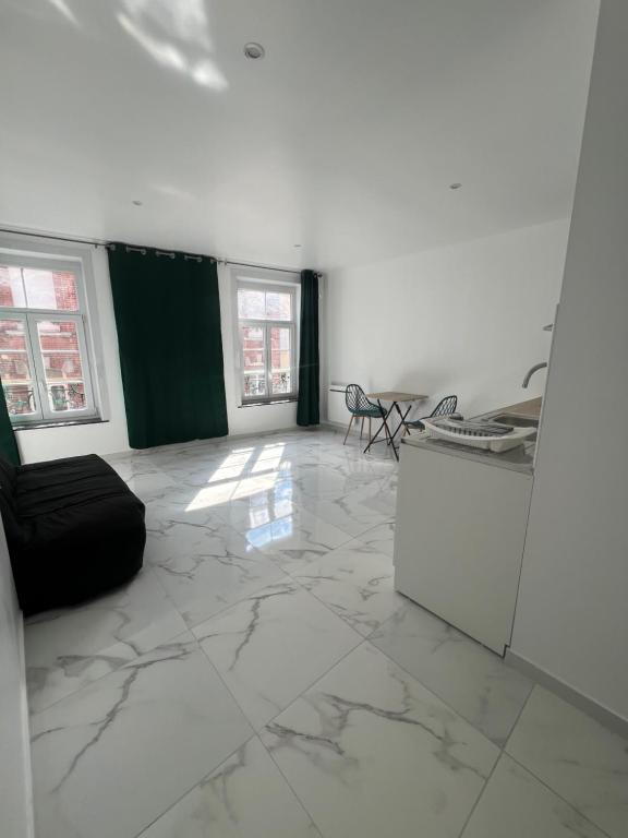 - un salon avec un grand sol en marbre et des fenêtres dans l'établissement Victor 2, à Avesnes-sur-Helpe