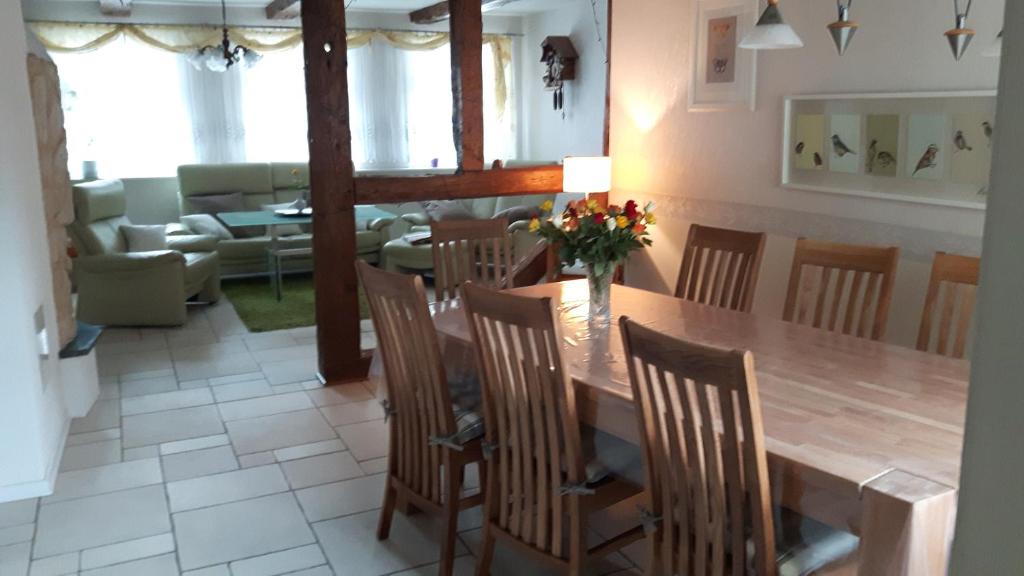 a dining room and living room with a table and chairs at Altstadt Ferienhaus in Wernigerode